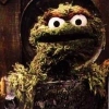 Oscar the Grouch peeking out from his trash can