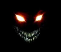 Creepy glowing-eyed demon face lurking in the dark