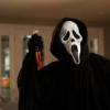 Ghostface lurking with a knife—classic horror movie still