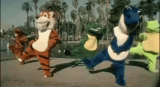 Costumed animal characters dancing in a goofy lineup