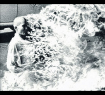 Monk engulfed in swirling flames, striking black-and-white GFX