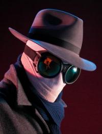 Mysterious goggled figure in trench coat and fedora