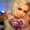 Blonde forum member selfie flexing colorful tattoo sleeve