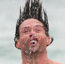 Guy shakes off water, hair sticks straight up