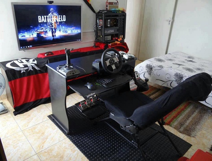 Epic gaming rig setup with racing wheel and Battlefield 3