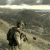 Soldier overlooking a war-torn valley town