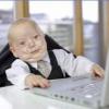 Baby suit-and-tie hacker grinding at the laptop