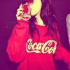 Girl in red hoodie sipping a Coca-Cola