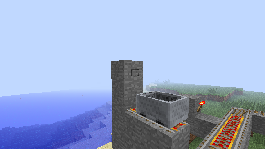 Minecraft build with rail tracks near ocean