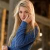 Blonde woman in blue sweater, generic stock-style photo