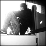Silhouette lost in thought, backlit by the window