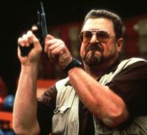 Movie still: the Dude abides, gun raised