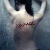 Moody portrait with 'x0mage' scrawled across a bare back