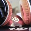 Retro pink headphones resting on a desk