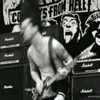 Guitarist mid-riff, gritty punk-rock concert energy