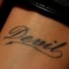 Devil script tattoo inked on someone's arm