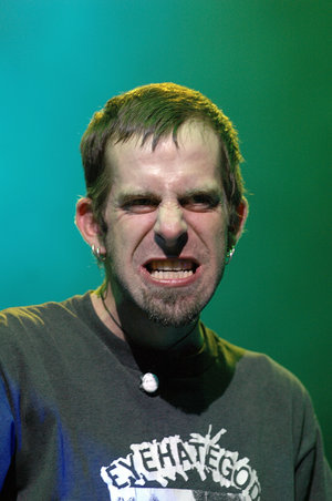 Intense singer mid-scream, EyeHateGod shirt on stage