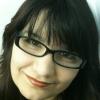 A classic forum profile pic, smiling behind glasses