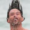 Splashy hair-flip moment caught mid-air at the beach