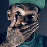 Portrait pic with tattoos and green cap vibe